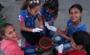 Syrian refugees planting flowers to represent the main topic of the event this year which is the link between water and nature. Photo: Nahed Mansour/Concern Worldwide.