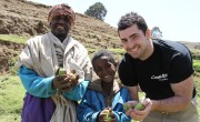 Smiling Apple Farmers, Father and son, Ebrie and Mohammed Ali Demsie with Rob Kearney showing their crops in Dessie Zuria, Ethiopia. Photo: Jennifer Nolan / Concern Worldwide