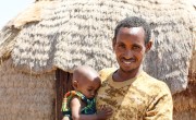 Ishmael Ali outside the tukal he shares with his wife Khayro and their four children. Photo: Jennifer Nolan / Concern Worldwide.