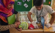 Concern staff in Cox's Bazar screen Azara* for malnutrition. Photo: Abir Abdullah / Concern Worldwide.