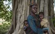 Marie Mbendu (40) with 15-month-old twins Dorcas, in her arms, and Moise, on her back. Photo: Chris de Bode.