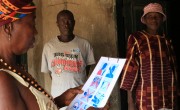 A resident of Bassaia Village Tonkolili District Northern Sierra Leone looks at a COVID-19 poster distributed by Concern Worldwide after a sensitization session. Photo: Mohamed Saidu Bah / Concern Worldwide