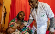 Nayla's son Jasim receives a check-up from Concern health staff.