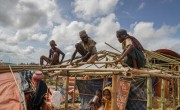Rohingya men rebuilding their tents before the monsoon arrives.