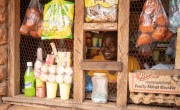 Woman smiling looking through hatch in her shop