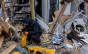 Man sorting through rubble