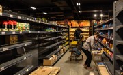 Supermarket staff stocking empty shelves
