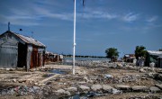 Shoreline behind house made of corrugated iron