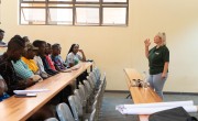 Blonde woman in Concern t-shirt teaching row of university students