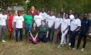 Group of people in white t-shirts standing in garden