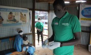 Man in green t-shirt and face mask in Covid clinic