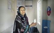 Woman smiling after receiving water at community clinic in Bangladesh