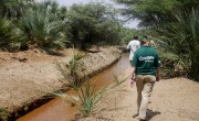 Concern staff walking alongside canal in Kangalita, Kenya