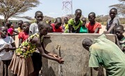 Children washing hands at tap installed by Concern