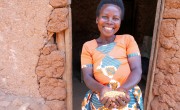 Marie-Claire with a handful of soya beans that she has harvested from her land and will sell to her neighbours.