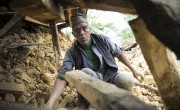 Krishna Prasad Sapkota digs through the mud and stones of what used to be his home to see if any of their belongings could be recovered. "I am 70 years old and everything is destroyed," he said. (Photo: Crystal Wells/Concern Worldwide)