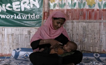 Woman feeding her child.