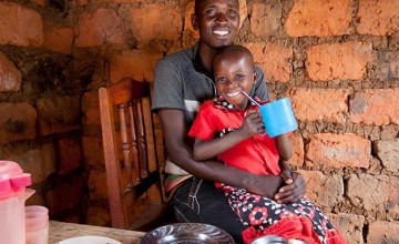 Megisela Muhoza (6) daughter of Gerard Ndabahekeye (28) at their new kitchen table and chairs. Photo: Abbie-Trayler Smith / Concern Worldwide.