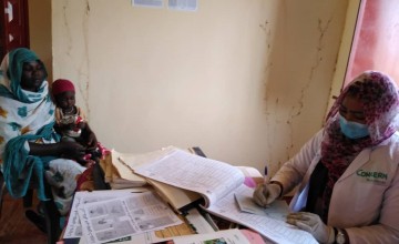 Concern nutrition staff observing basic protection while treating people. West Darfur, Sudan.
