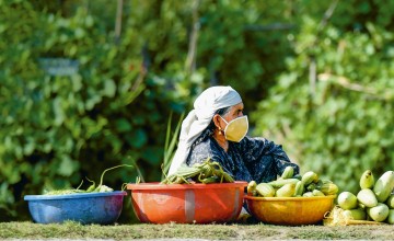 A roadside vendor selling vegetables waits for customers on the banks of the Dal Lake in Srinagar, Kashmir, on July 24, 2020. AFP/Tauseef Mustafa 2020. 