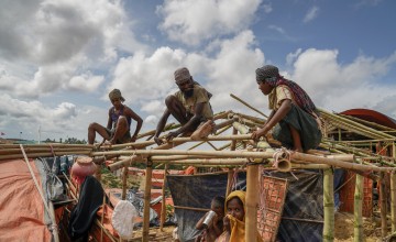 Rohingya men rebuilding their tents before the monsoon arrives.