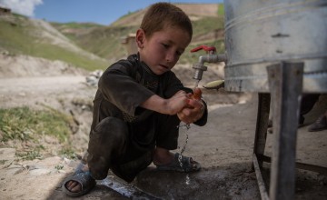 Child uses handwashing station in Afghanistan