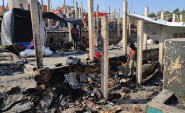 Rohingya refugees search among the ruins of shelters destroyed by the blaze at Cox's Bazar.