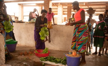Rose and Stone selling freshly picked produce from the family farm in Nsanje, Malawi. Stone and Rose are participants in the Graduation Programme / Umodzi project. Photo: Chris Gagnon/Concern Worldwide.
