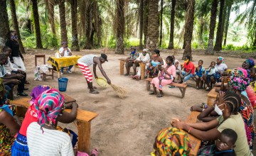 Man sweeping during community dialogue session