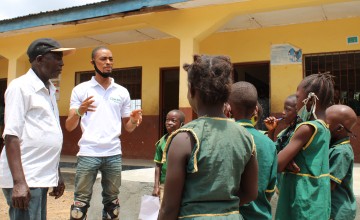 SLM facilitators speaking to children in Tonkolili.