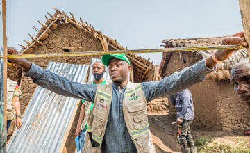 Concern staff check measurements of latrines