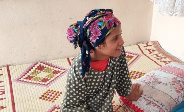 Eslem sits in her home in Turkey