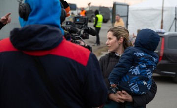Woman holding her son at Polish/Ukrainian border