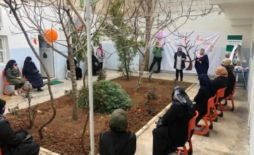 People sitting around small garden