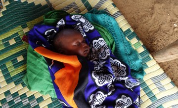 An infant swaddled in blankets in Chad