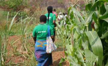 Three women walking through fields