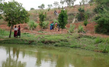 Group of women approaching banks of pond