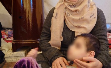 Nayila* with one of her daughters, who has severe disabilities