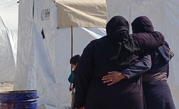 Syrian women comfort each other following the February 6, 2023 earthquake