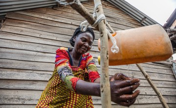 Furaha Mauwa uses jerry can to wash hands in DRC