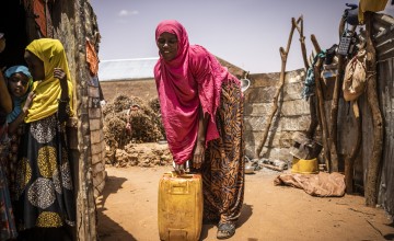 Ayaan collects water in a jerry can