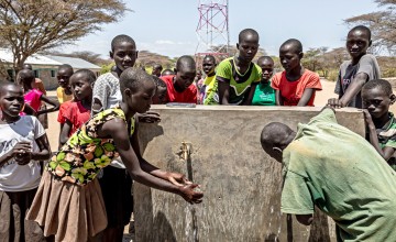 Children wash their hands at tap outside Naoros Primary School