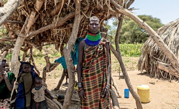 Ewalan Mojong and her children beside her hut
