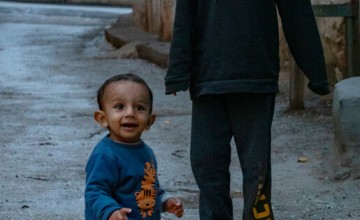 Nadia's* children Abdel* and Rami* playing on the street outside their house in Malatya