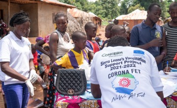 Concern vaccination team member records community members' information at a clinic