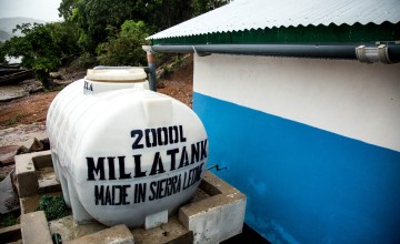 A rainwater catchment system fills a water tank on the community latrine built by Concern Worldwide in the east of Freetown, Sierra Leone (Photo: Michael Duff)