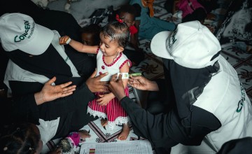 Community Health Volunteer (CHVs) conducting nutrition screening on a child in Yemen.