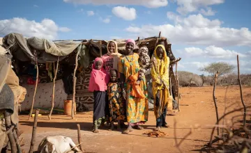 Mumina Mohamed poses for a photograph with her five children outside her home in Subo village. Mumina participated in Concern Worldwide’s Lifesaving Education and Assistance to Farmers (LEAF) project in Tana River County, Kenya. The program helped address climate change through resilient agricultural methods, and centered women farmers in the process. (Photo: Lisa Murray/Concern Worldwide)