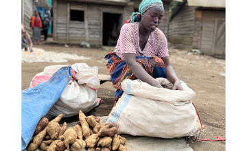After participating in a Concern training on income-generating activities and receiving cash assistance, Furaha now has a prosperous business in wholesale and retail where she sells potatoes in her village market in Ndobogo, DRC. (Photo: Ariane Rwankuba/Concern Worldwide)
