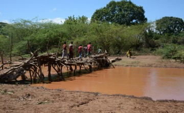 This river in Tana River County, Kenya, only fills up when there is rain, on any other day, it is a passage from one side of the community to the other. This region however is prone to frequent flooding, washing the makeshift passage away. Photo: Shaloam Strooper/Concern Worldwide